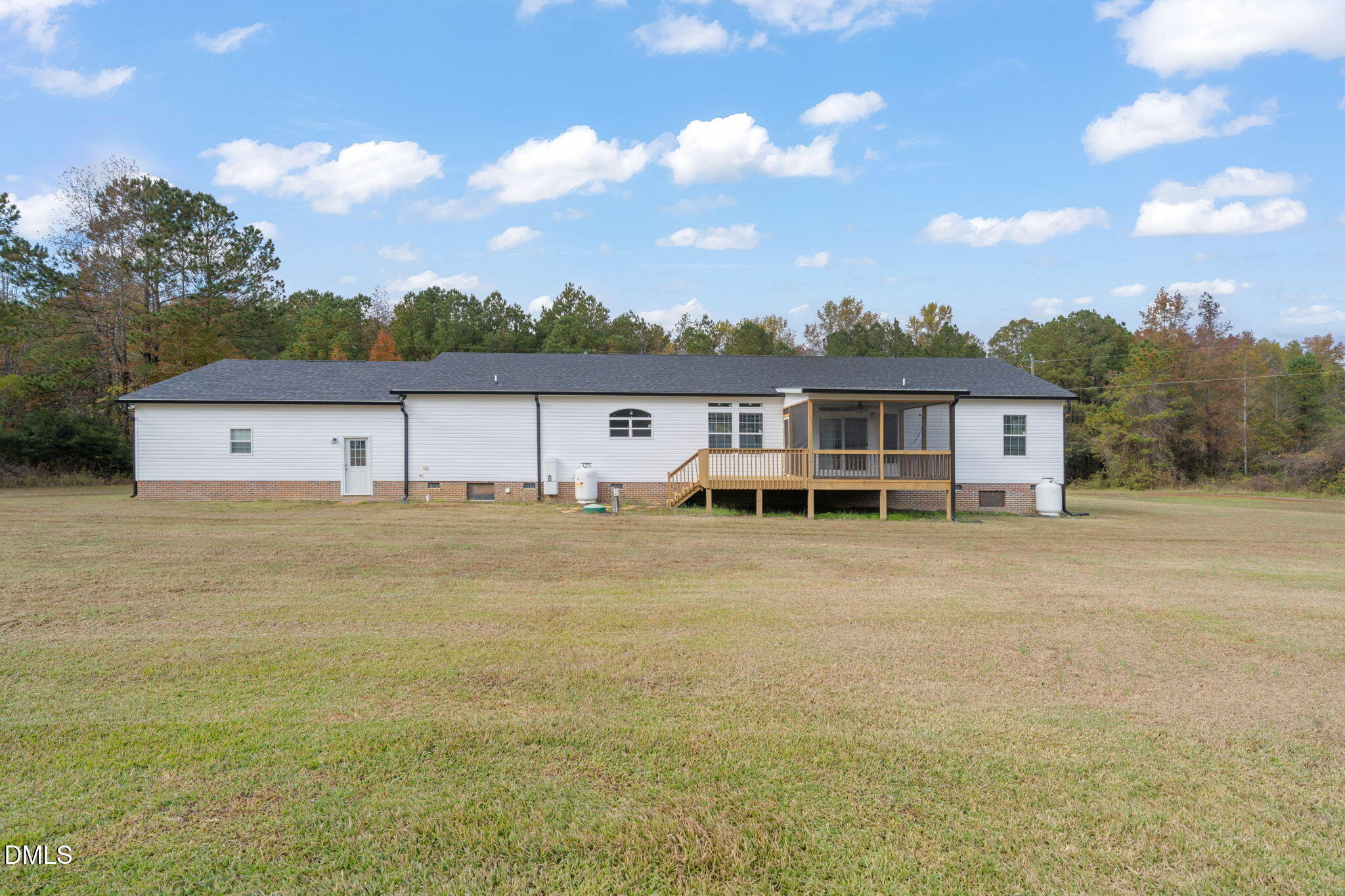 748 Gum Swamp Road Four Oaks, NC 27524 - Photo 42 of 43 a front view of a house with a garden and deck