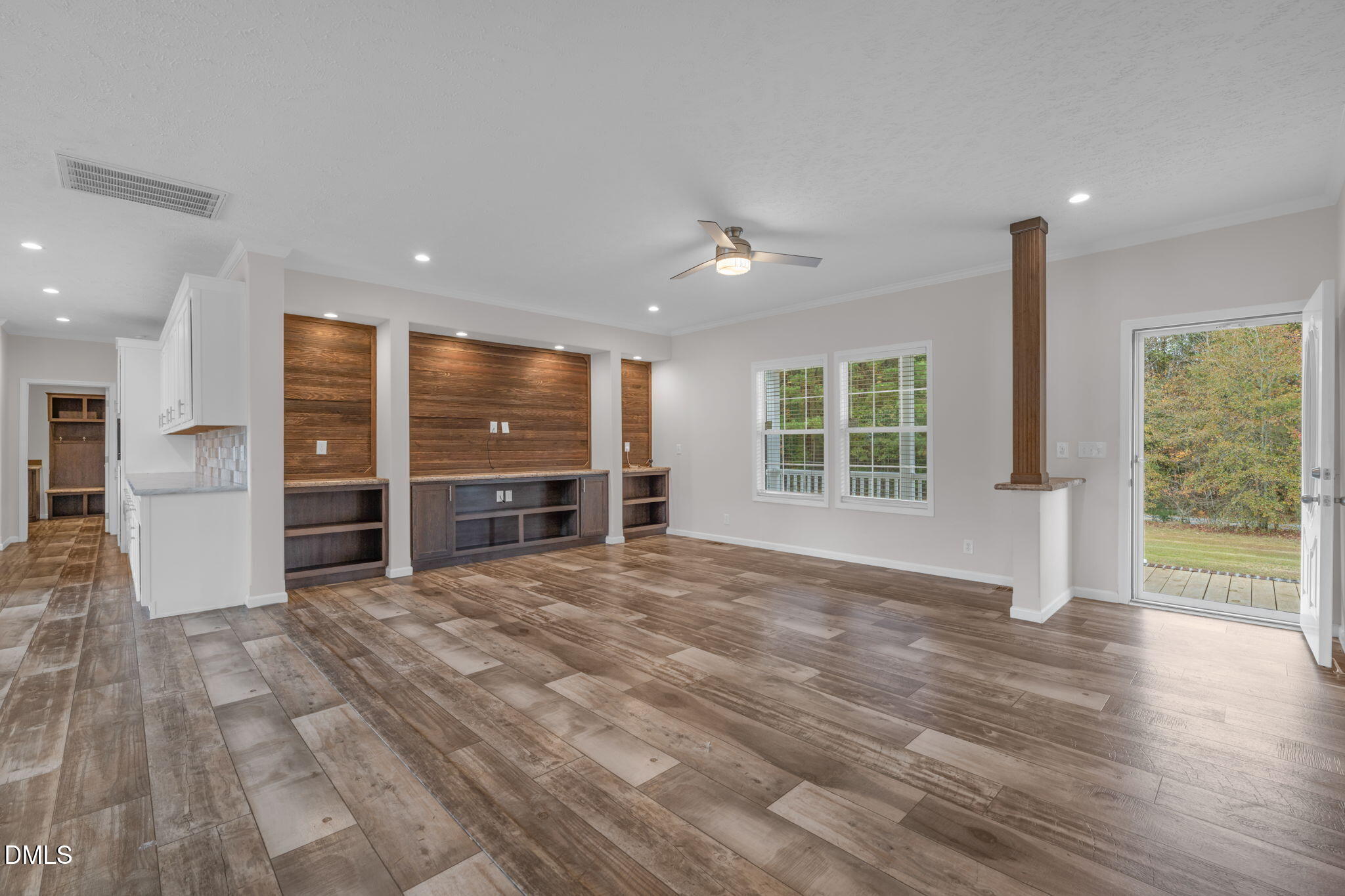 748 Gum Swamp Road Four Oaks, NC 27524 - Photo 5 of 43 a view of an empty room with a window and wooden floor