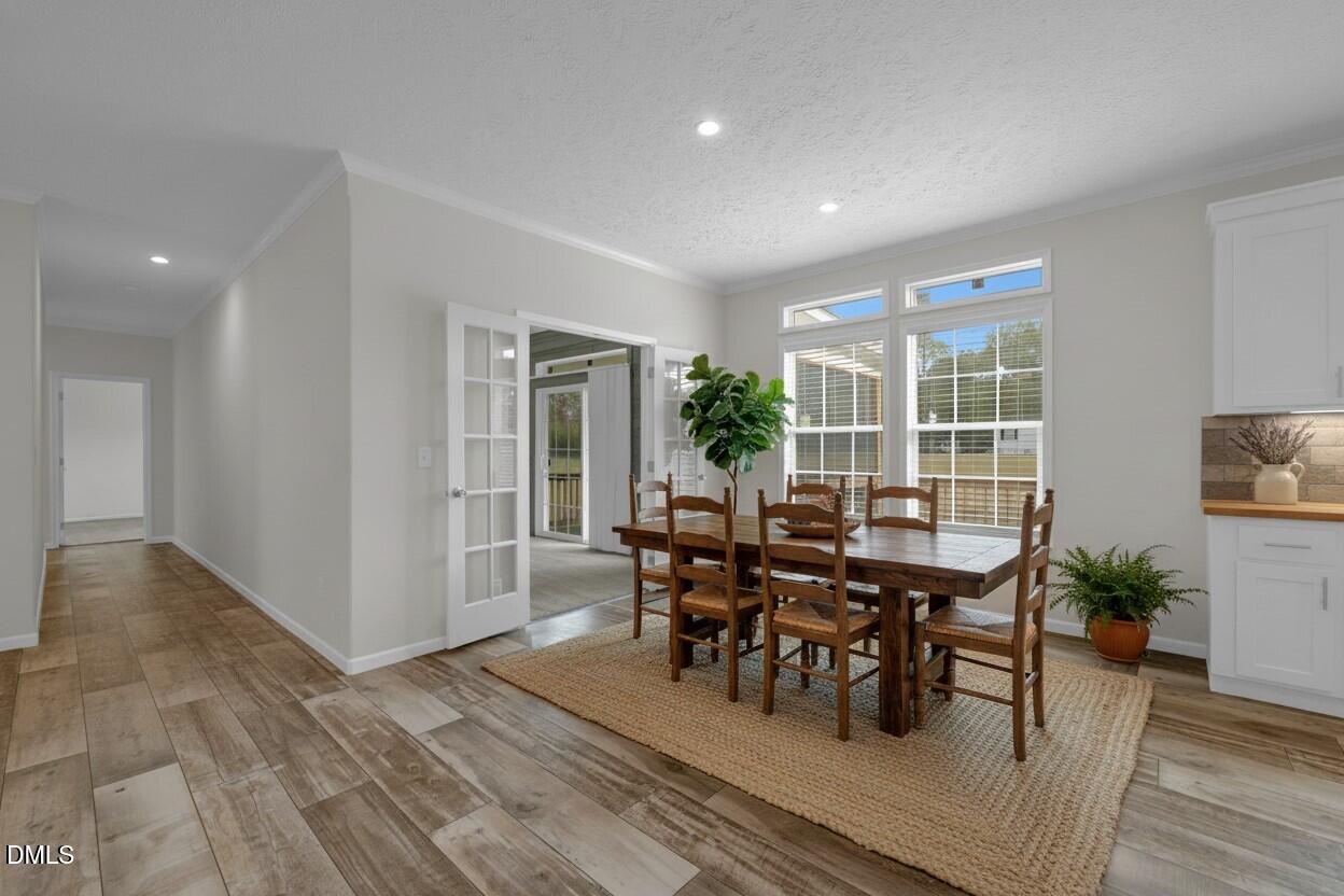 748 Gum Swamp Road Four Oaks, NC 27524 - Photo 6 of 43 a view of a dining room with furniture and wooden floor