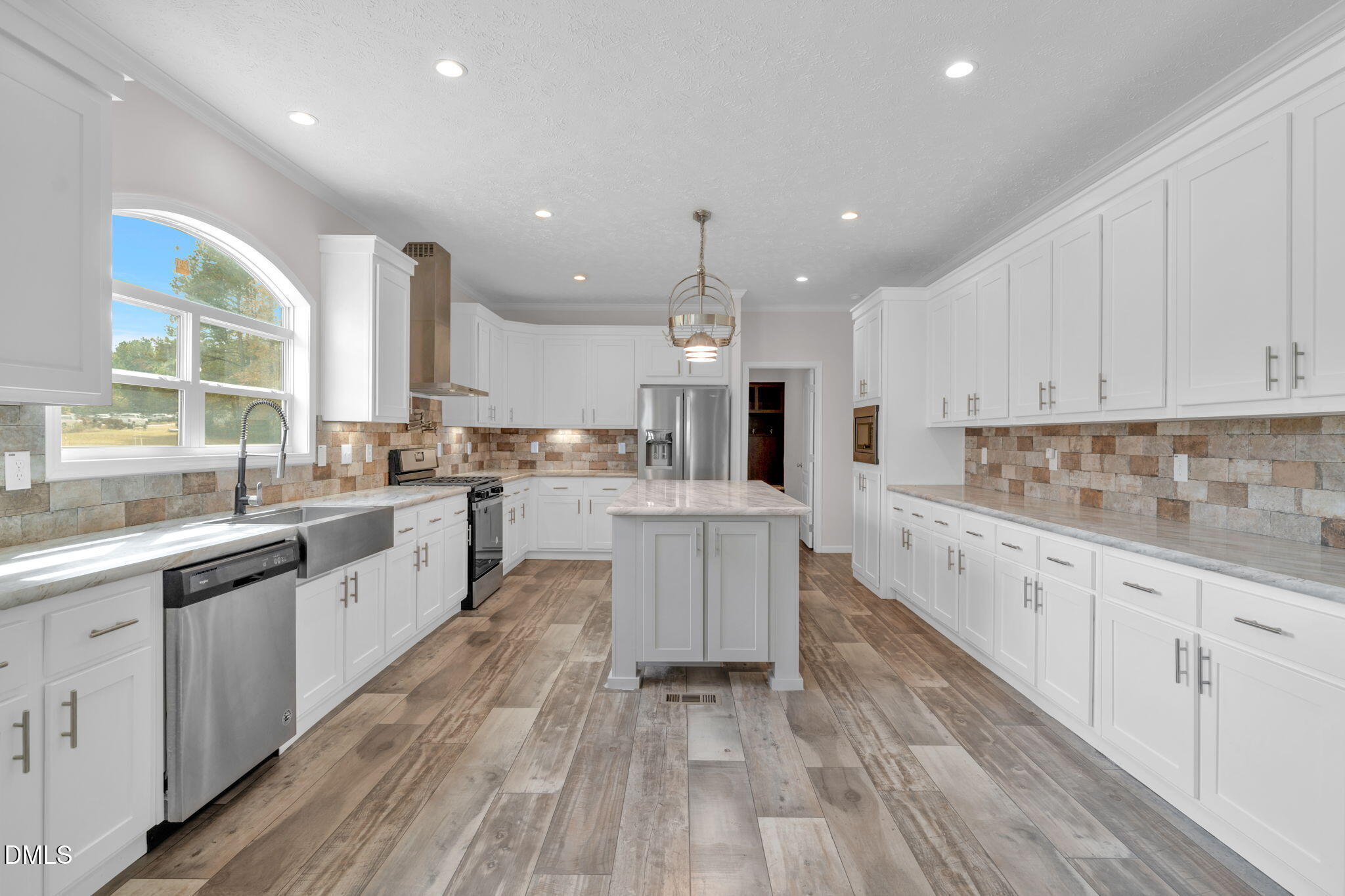 748 Gum Swamp Road Four Oaks, NC 27524 - Photo 8 of 43 a large kitchen with cabinets wooden floor and stainless steel appliances