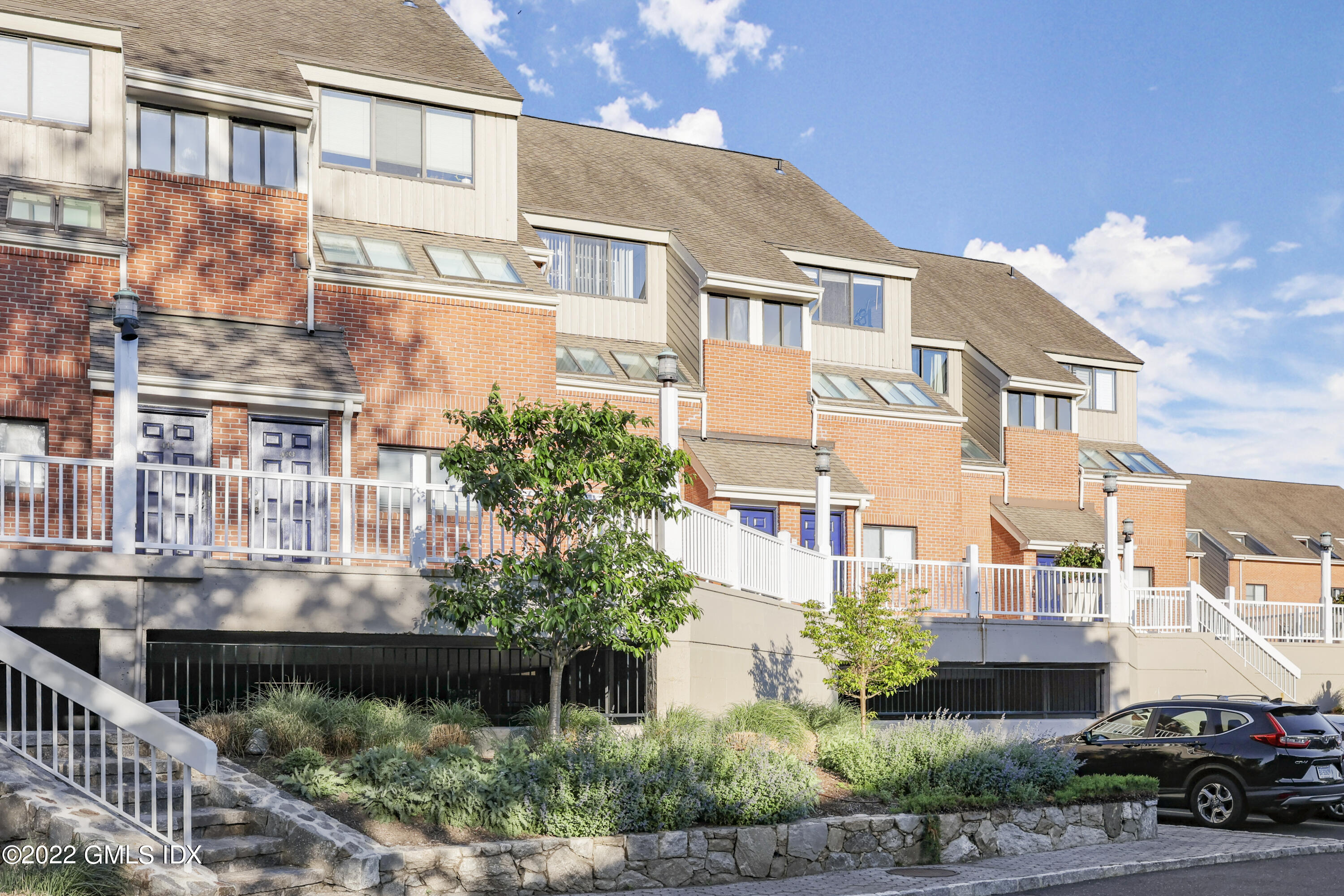 a car parked in front of a brick house