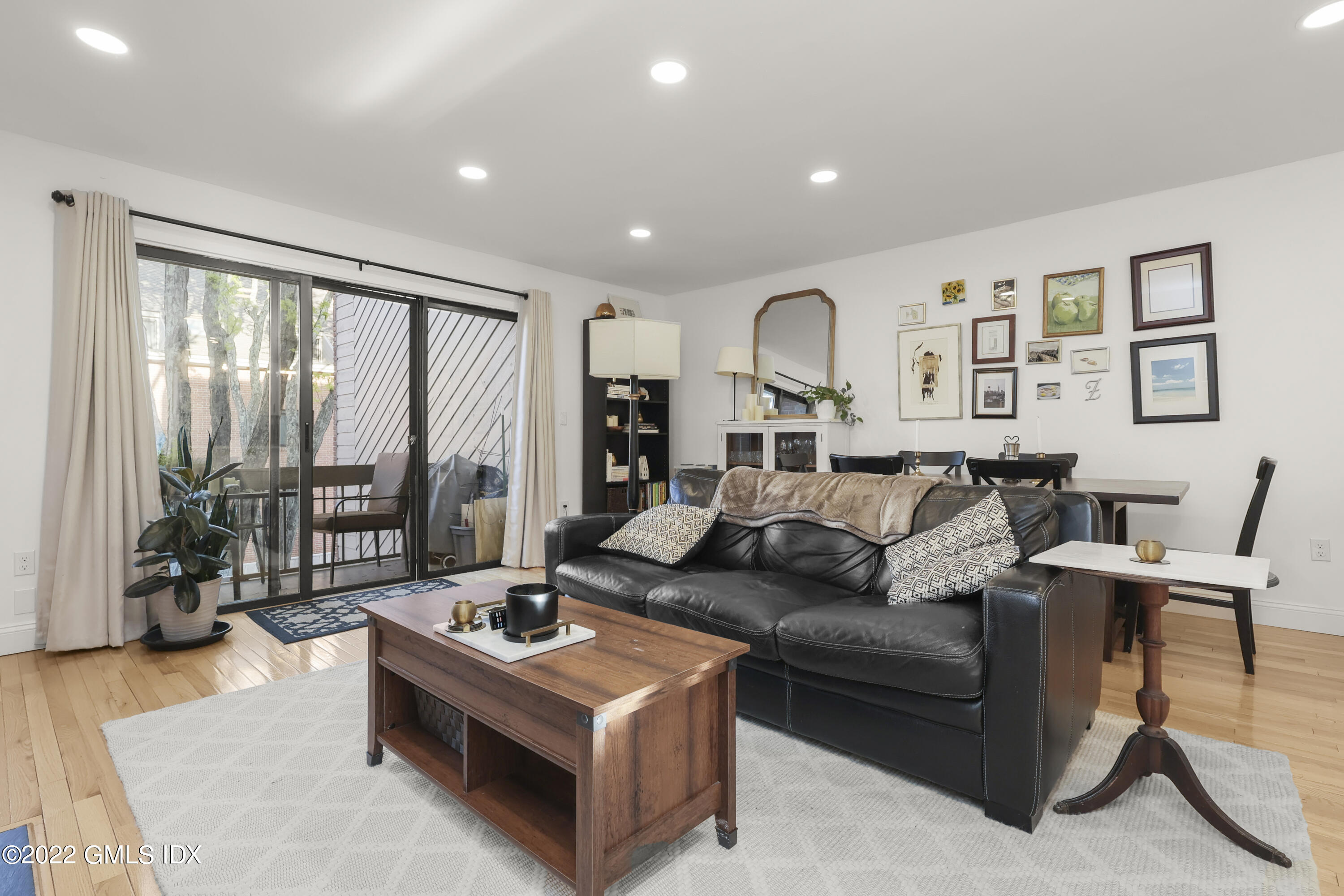 9 River Road, Unit 406 Cos Cob, CT 06807 - Photo 13 of 23 a living room with furniture and large windows