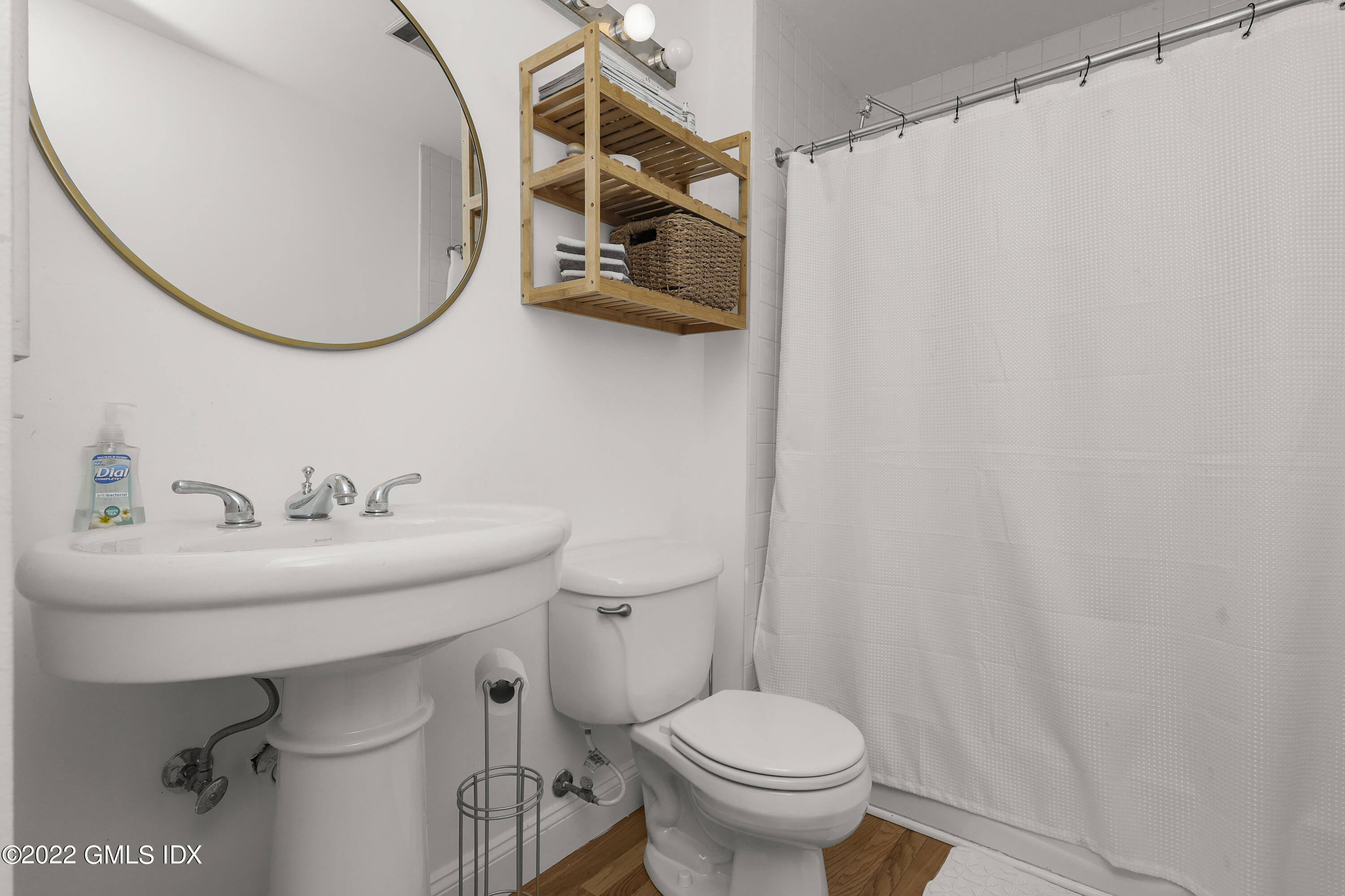 9 River Road, Unit 406 Cos Cob, CT 06807 - Photo 16 of 23 a bathroom with a sink a toilet and a mirror