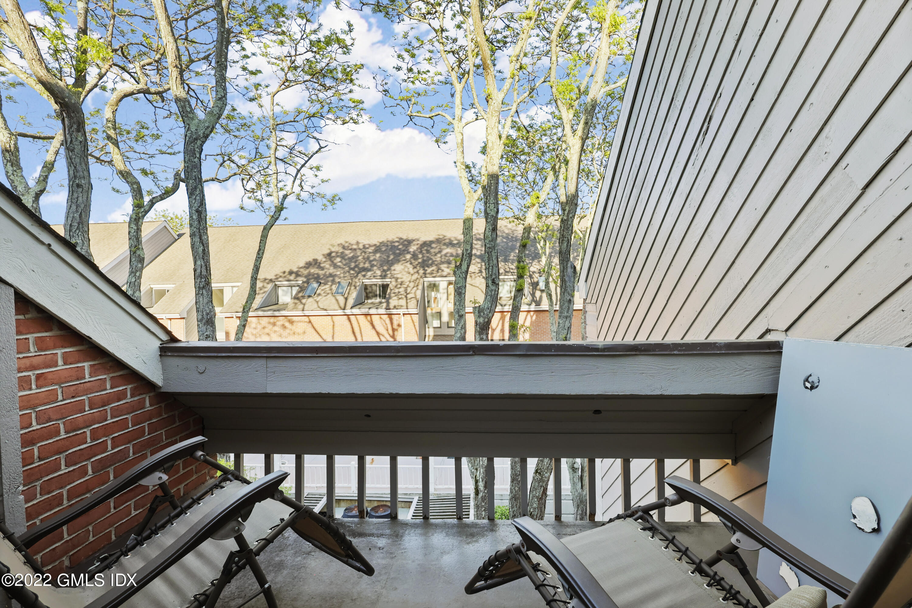 9 River Road, Unit 406 Cos Cob, CT 06807 - Photo 17 of 23 a view of porch with a bench