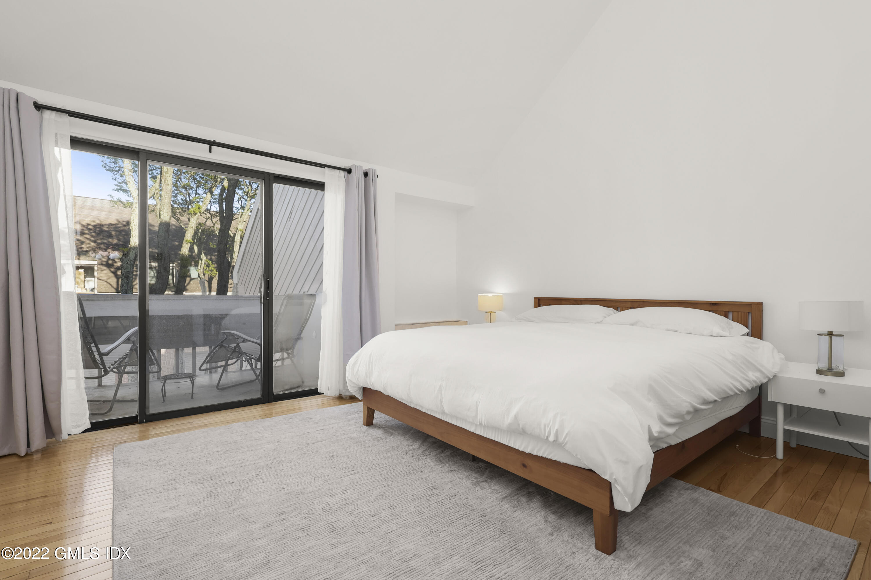 9 River Road, Unit 406 Cos Cob, CT 06807 - Photo 20 of 23 a large bed sitting in a room next to a window