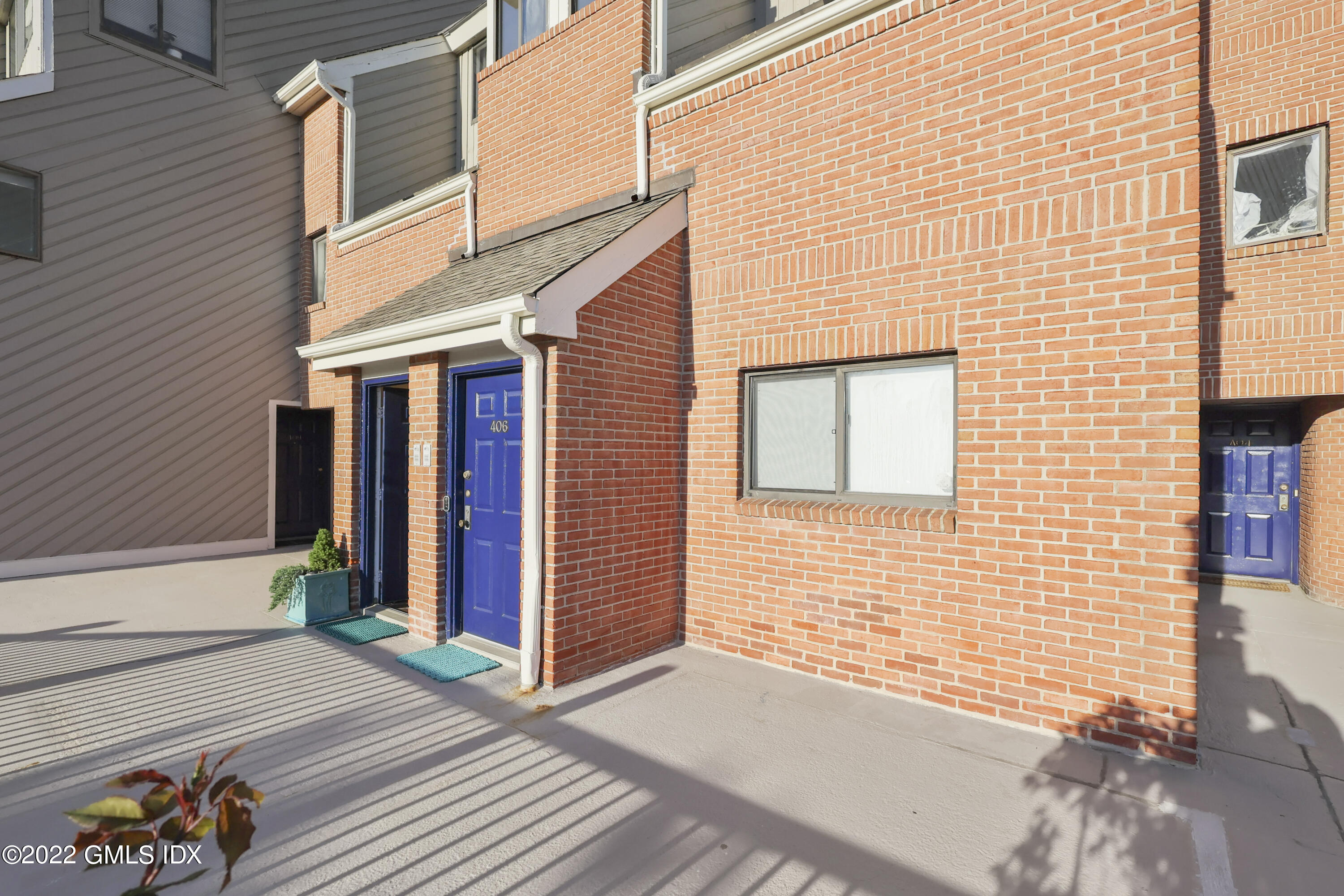 9 River Road, Unit 406 Cos Cob, CT 06807 - Photo 4 of 23 a view of a brick house with an outdoor space