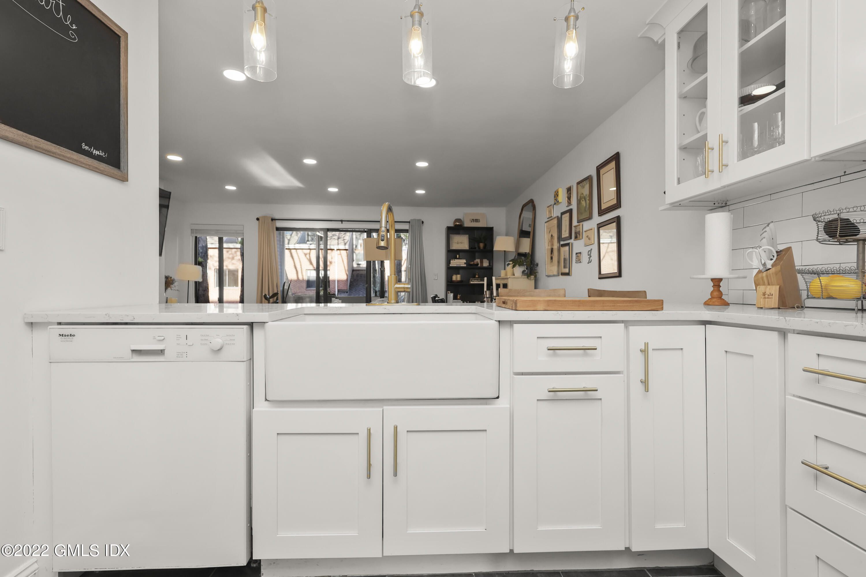 9 River Road, Unit 406 Cos Cob, CT 06807 - Photo 7 of 23 a kitchen with white cabinets and white appliances