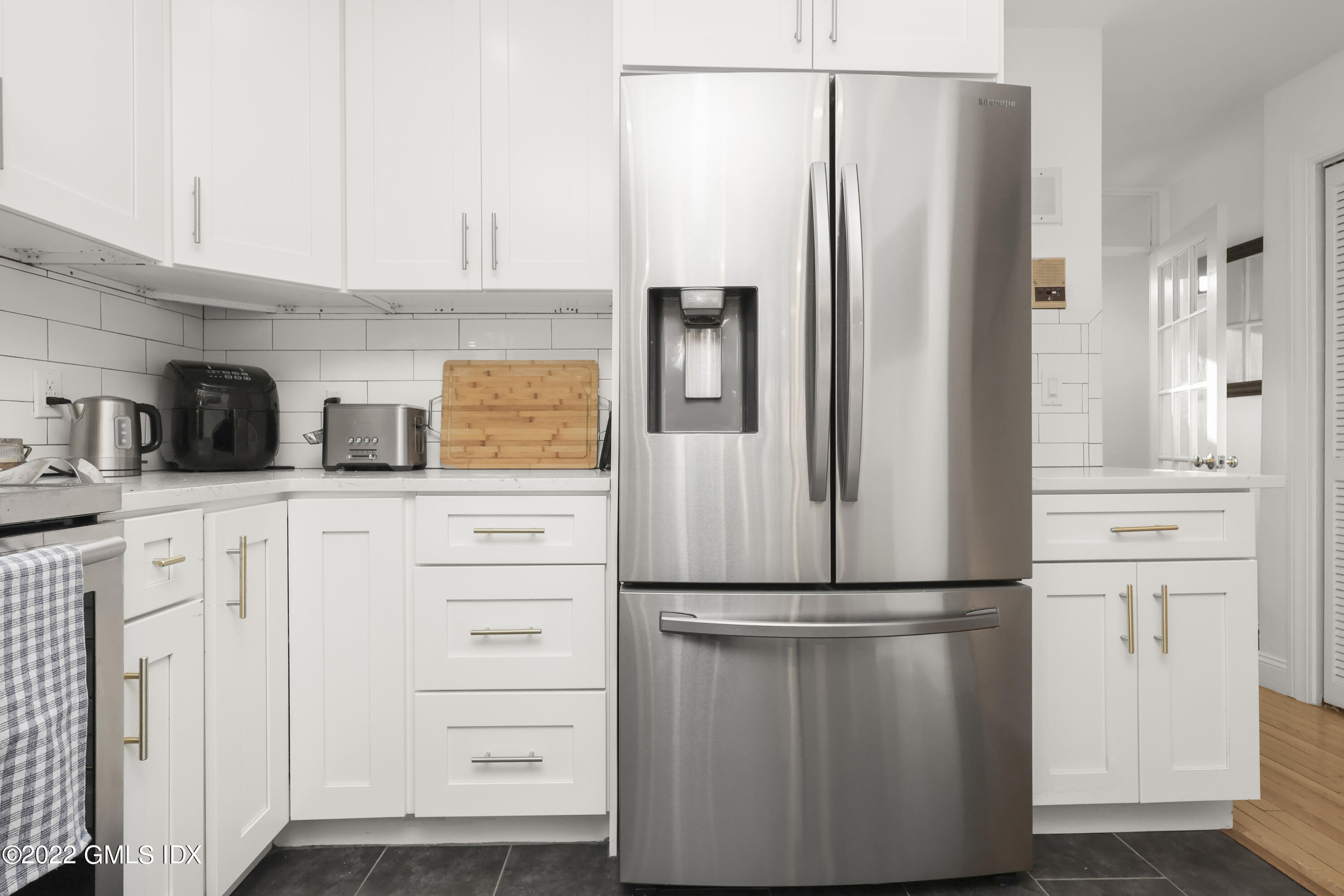 9 River Road, Unit 406 Cos Cob, CT 06807 - Photo 8 of 23 a kitchen with appliances cabinets and a refrigerator