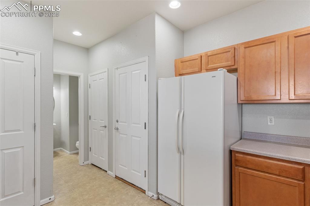 7644 Sandy Springs Point Fountain, CO 80817 - Photo 13 of 27 a view of a kitchen with white cabinets and refrigerator