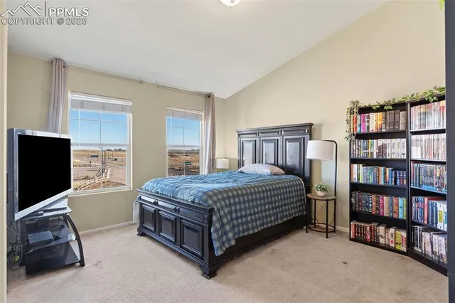 a bedroom with a bed and flat screen tv