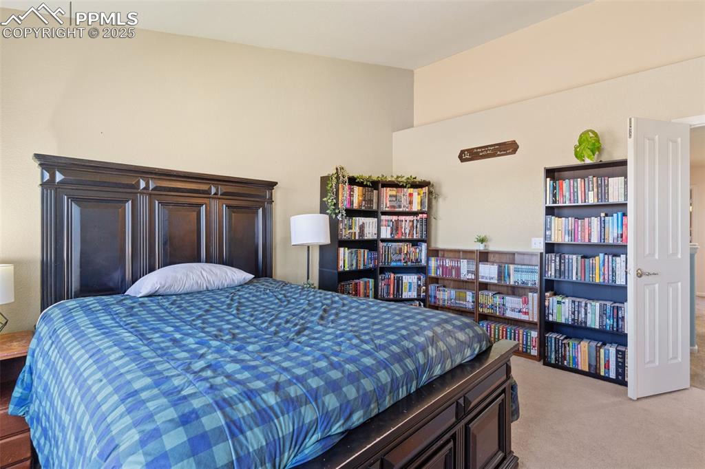 7644 Sandy Springs Point Fountain, CO 80817 - Photo 19 of 27 a bedroom with a bed and a book shelf