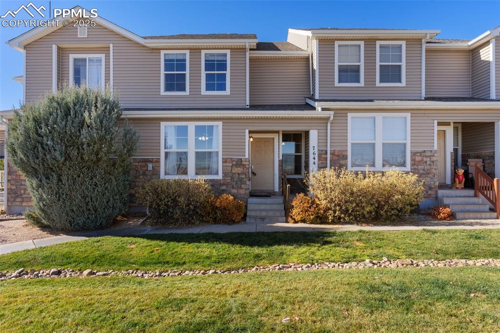 7644 Sandy Springs Point Fountain, CO 80817 - Photo 2 of 27 a front view of a house with a yard