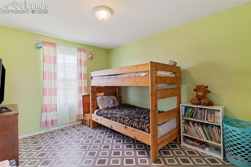 7644 Sandy Springs Point Fountain, CO 80817 - Photo 25 of 27 a bedroom with a chair and deck