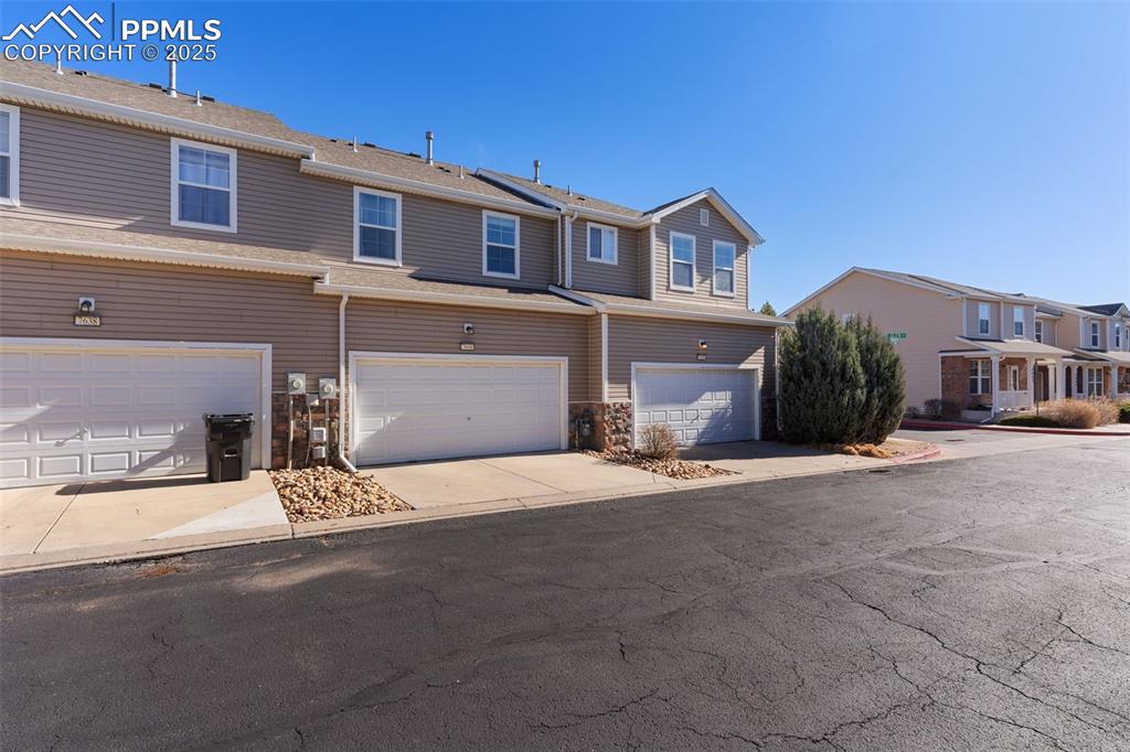 7644 Sandy Springs Point Fountain, CO 80817 - Photo 27 of 27 a front view of a house with a yard and garage