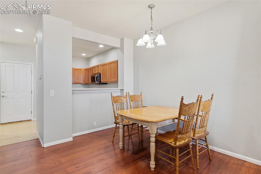 7644 Sandy Springs Point Fountain, CO 80817 - Photo 9 of 27 a view of a dining room with furniture and wooden floor
