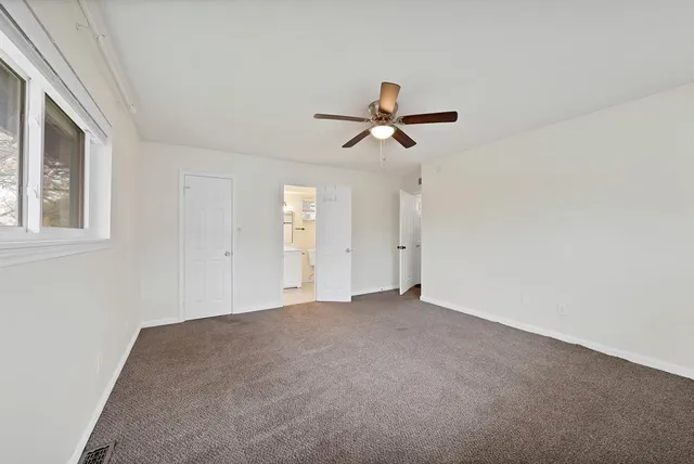 a view of empty room with ceiling fan