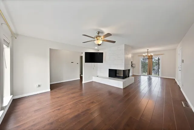 a view of an empty room with wooden floor