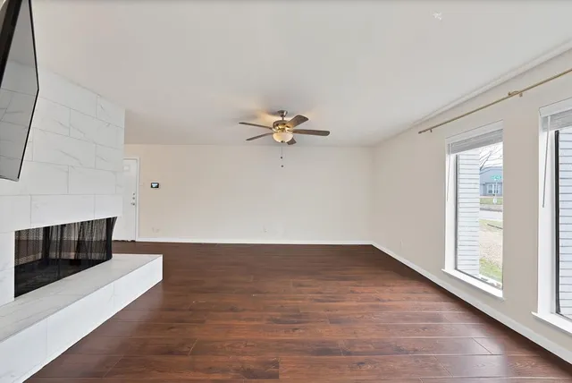 wooden floor in an empty room with a window