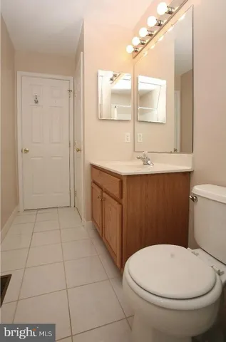 a bathroom with a sink a toilet and mirror