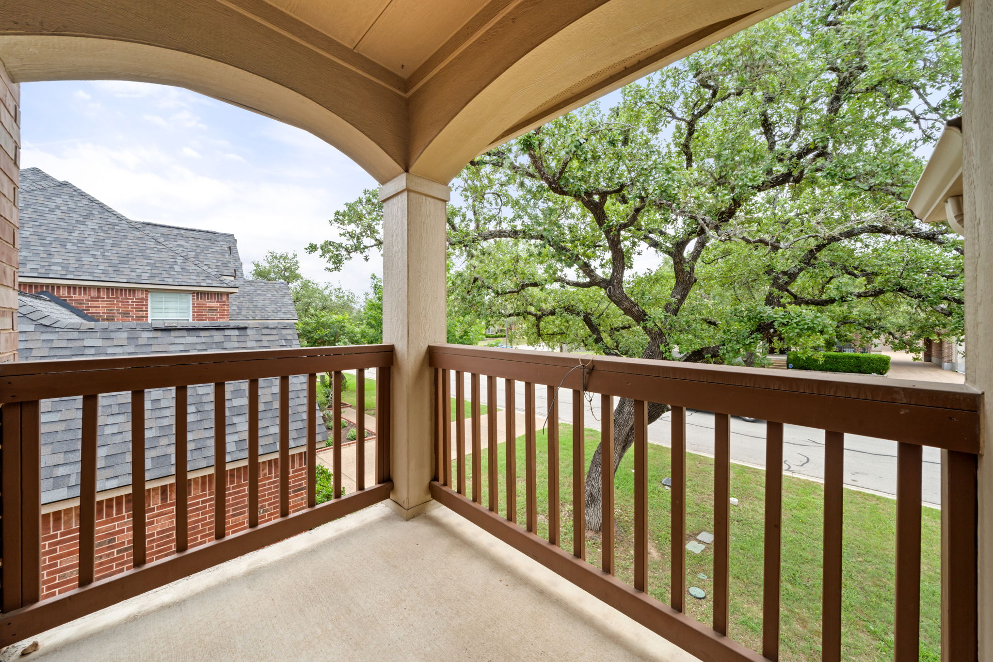 1581 Grassy Field Road Austin, TX 78737 - Photo 24 of 37 Arched architectural lines frame peaceful neighborhood views from this private covered balcony.