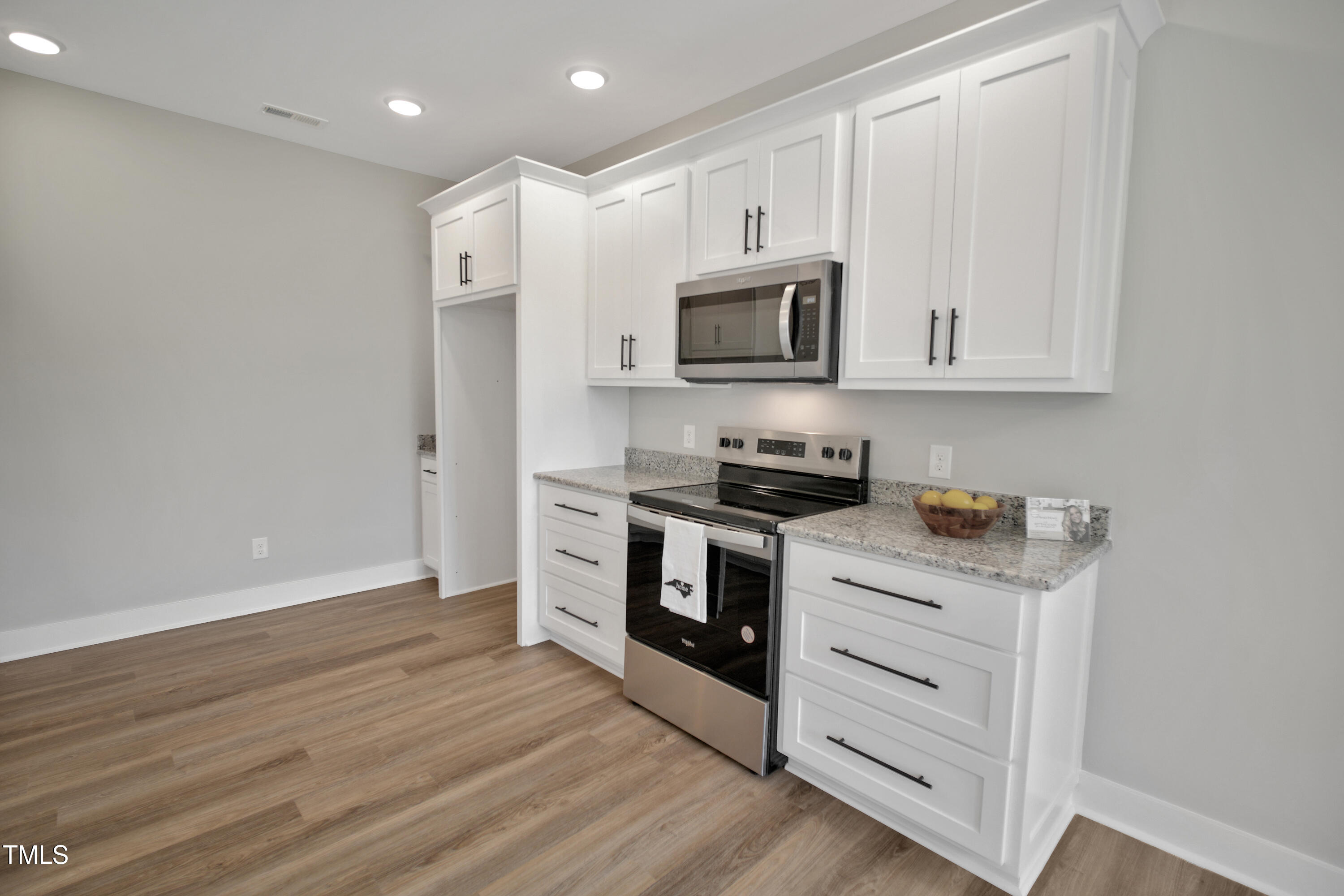 101 Sand Trap Lane Clinton, NC 28328 - Photo 11 of 49 a kitchen with stainless steel appliances white cabinets and a stove top oven