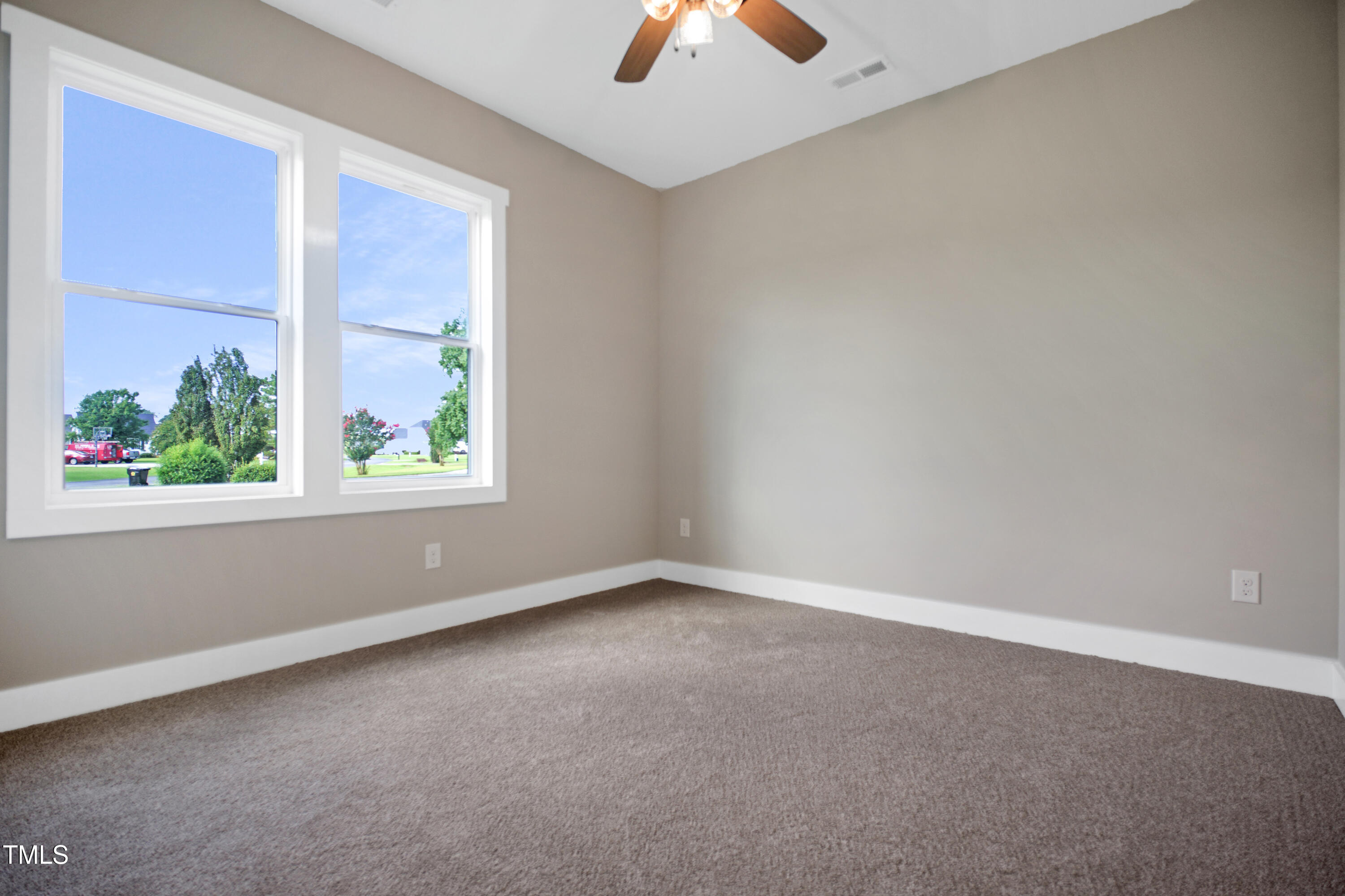 101 Sand Trap Lane Clinton, NC 28328 - Photo 41 of 49 an empty room with a window and a ceiling fan