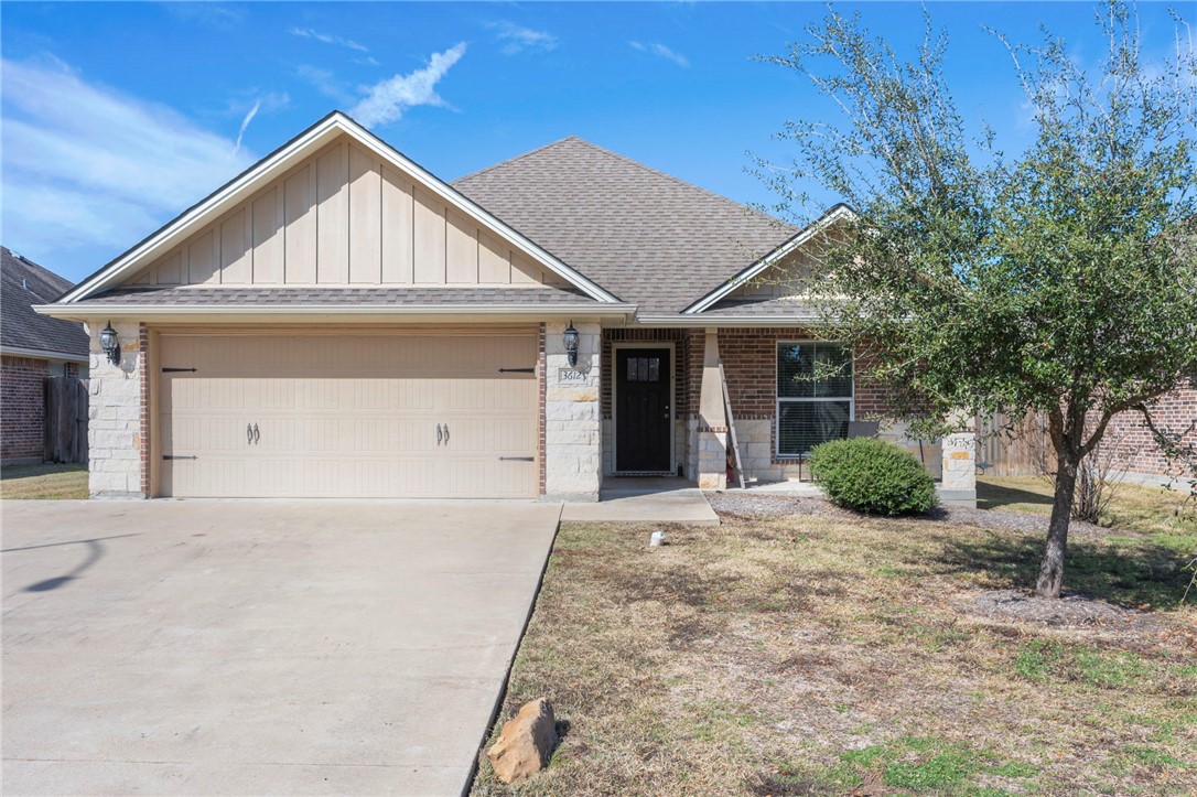 a front view of a house with yard and garage