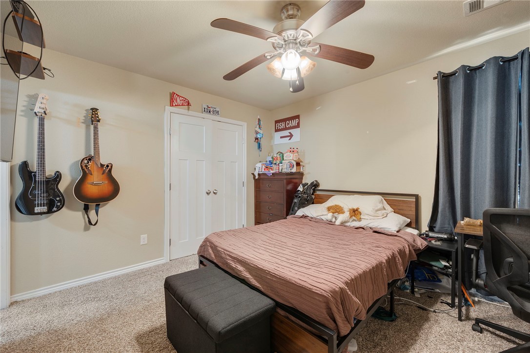 3612 Haverford Road College Station, TX 77845 - Photo 11 of 16 a bedroom with a bed and a chandelier