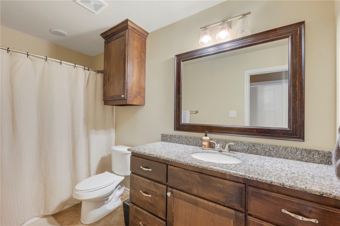 3612 Haverford Road College Station, TX 77845 - Photo 12 of 16 a bathroom with a granite countertop sink toilet and mirror