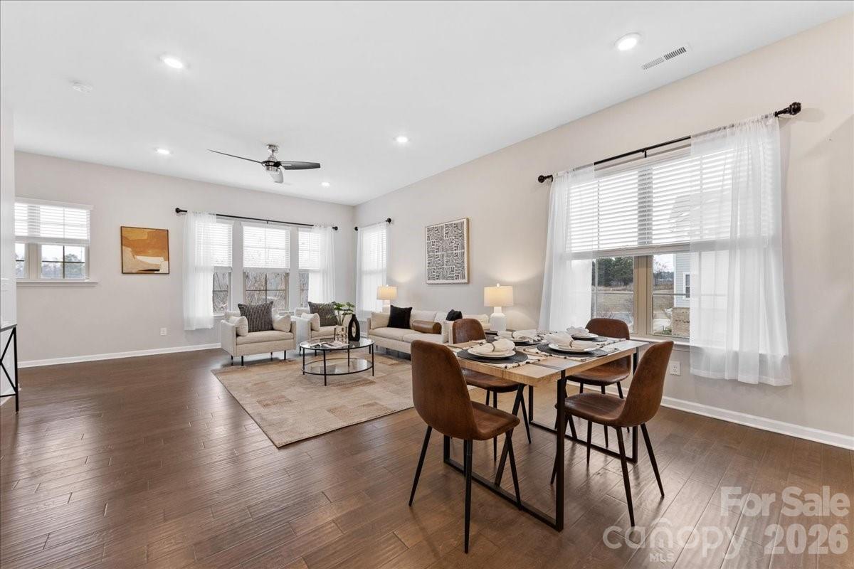 9205 Bluefield Street Charlotte, NC 28273 - Photo 12 of 48 a view of a dining room with furniture and wooden floor