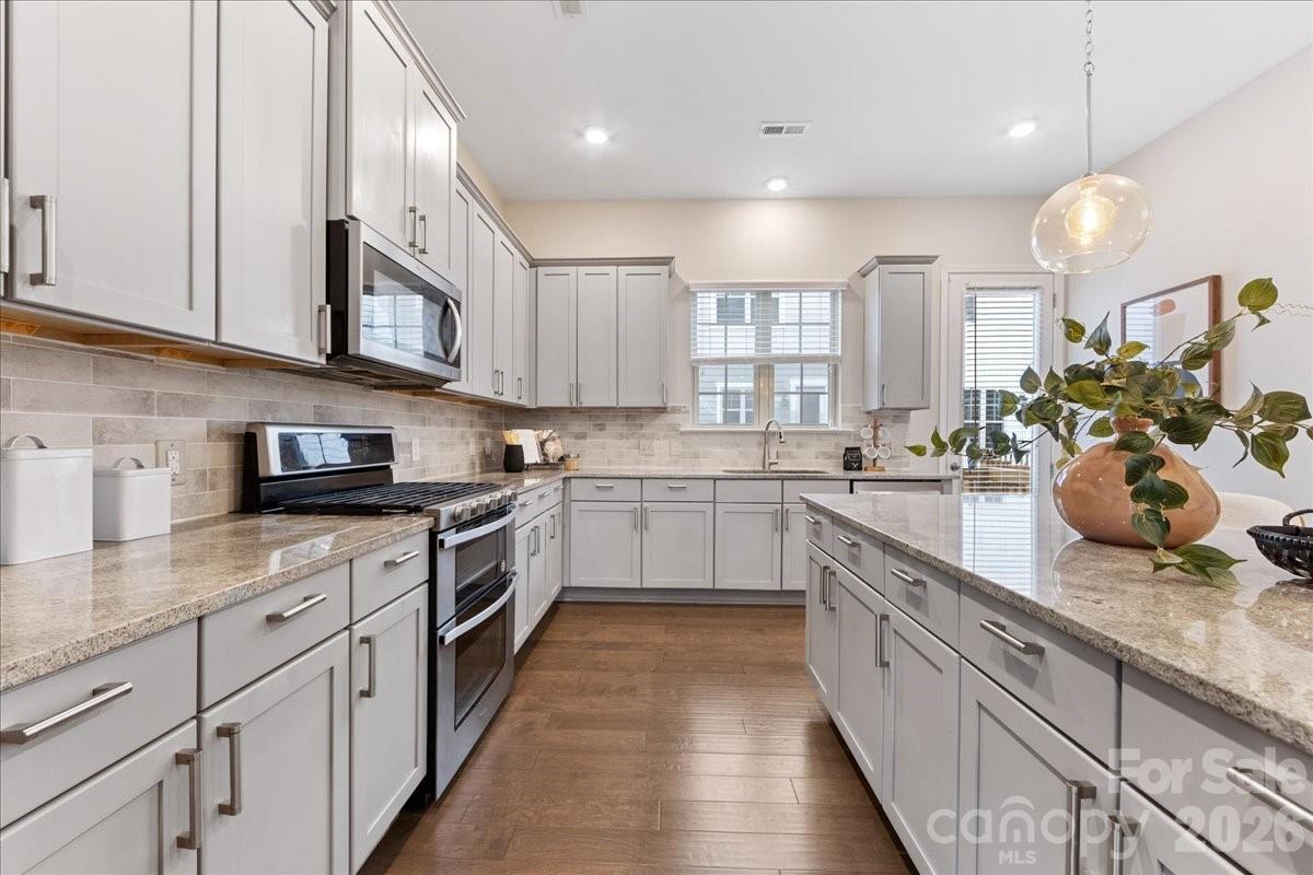 9205 Bluefield Street Charlotte, NC 28273 - Photo 17 of 48 a kitchen with stainless steel appliances granite countertop lots of counter space cabinets and a sink