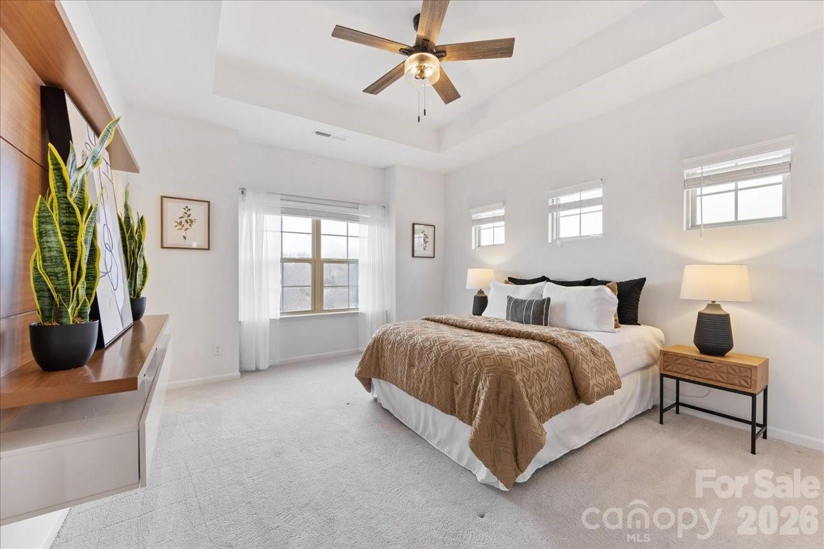 9205 Bluefield Street Charlotte, NC 28273 - Photo 26 of 48 a spacious bedroom with a bed a couch and a window