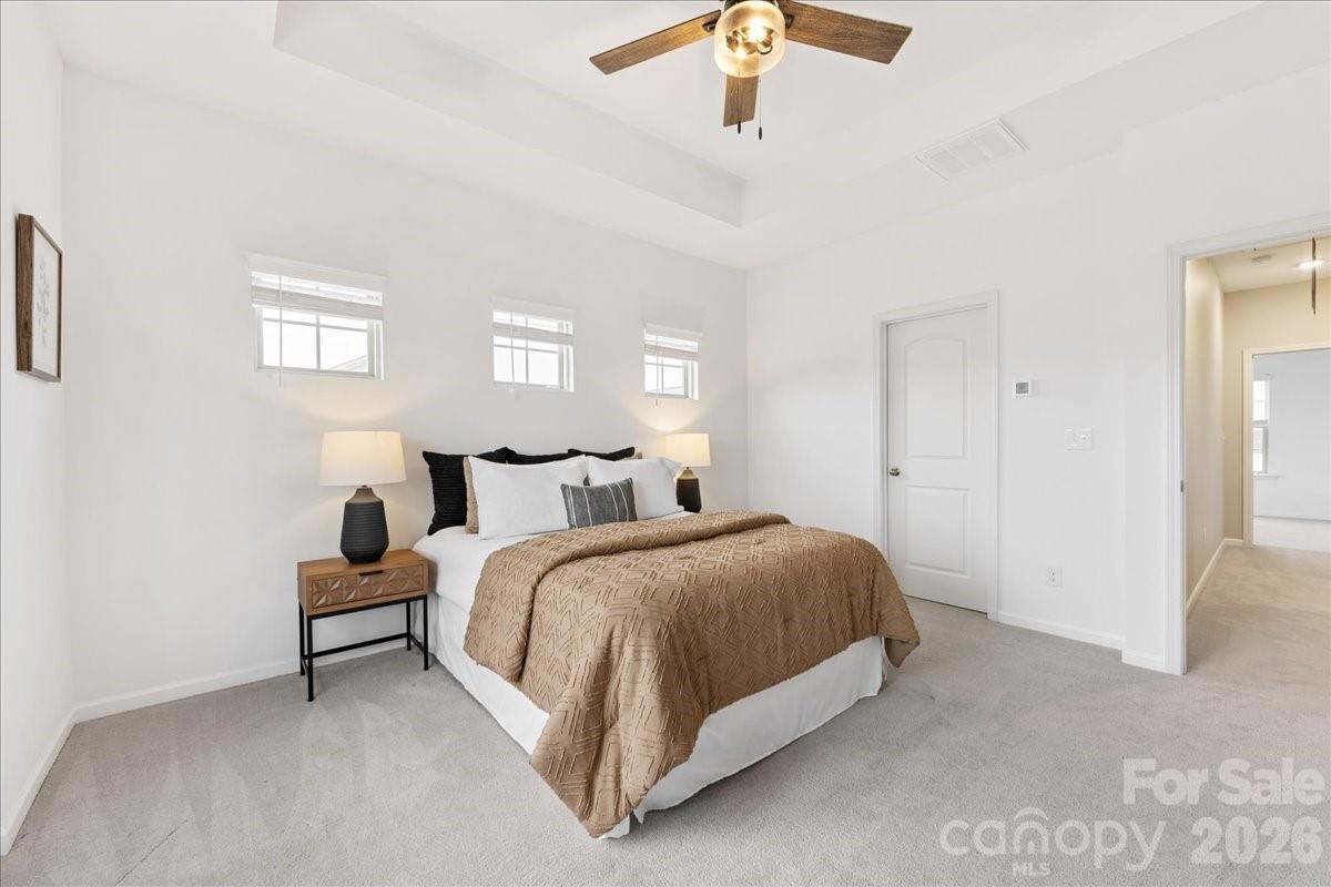 9205 Bluefield Street Charlotte, NC 28273 - Photo 27 of 48 a spacious bedroom with a bed and a chandelier