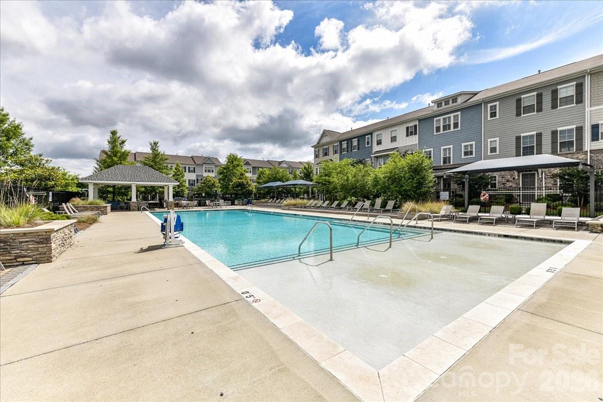 9205 Bluefield Street Charlotte, NC 28273 - Photo 42 of 48 a view of a swimming pool and a chairs and tables on the patio