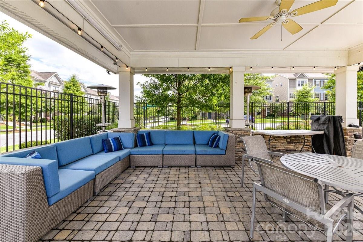 9205 Bluefield Street Charlotte, NC 28273 - Photo 44 of 48 a living room with patio furniture and a floor to ceiling window
