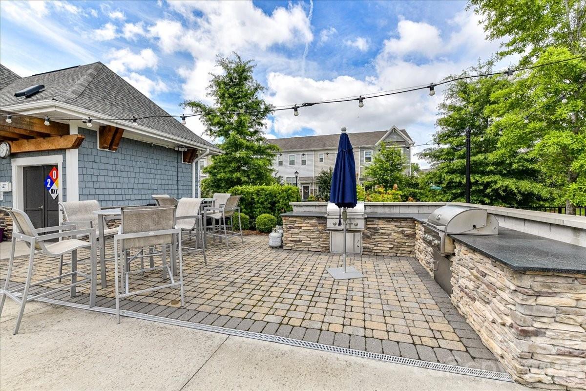 9205 Bluefield Street Charlotte, NC 28273 - Photo 46 of 48 a view of a patio with table and chairs and potted plants