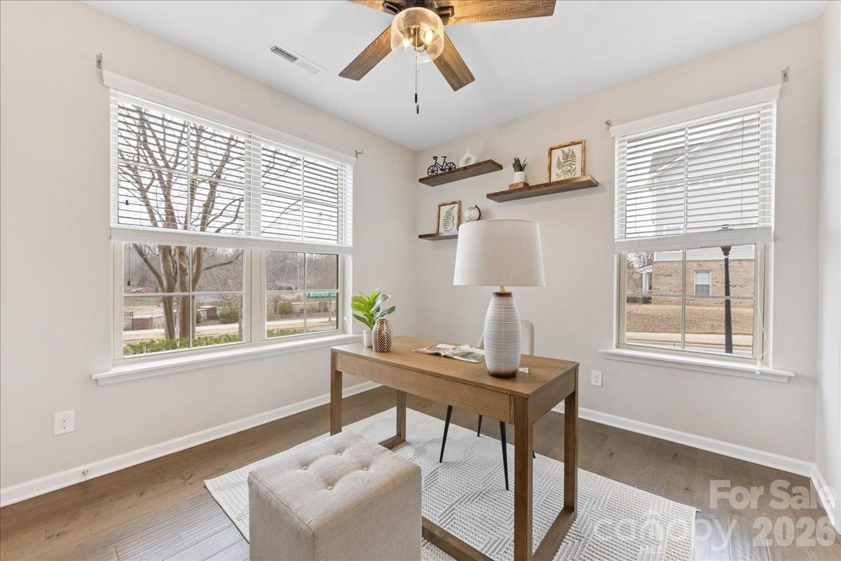 9205 Bluefield Street Charlotte, NC 28273 - Photo 6 of 48 a workspace with wooden floor and windows