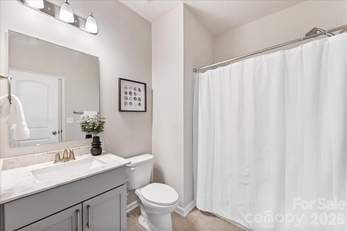 9205 Bluefield Street Charlotte, NC 28273 - Photo 7 of 48 a bathroom with a granite countertop sink and a toilet