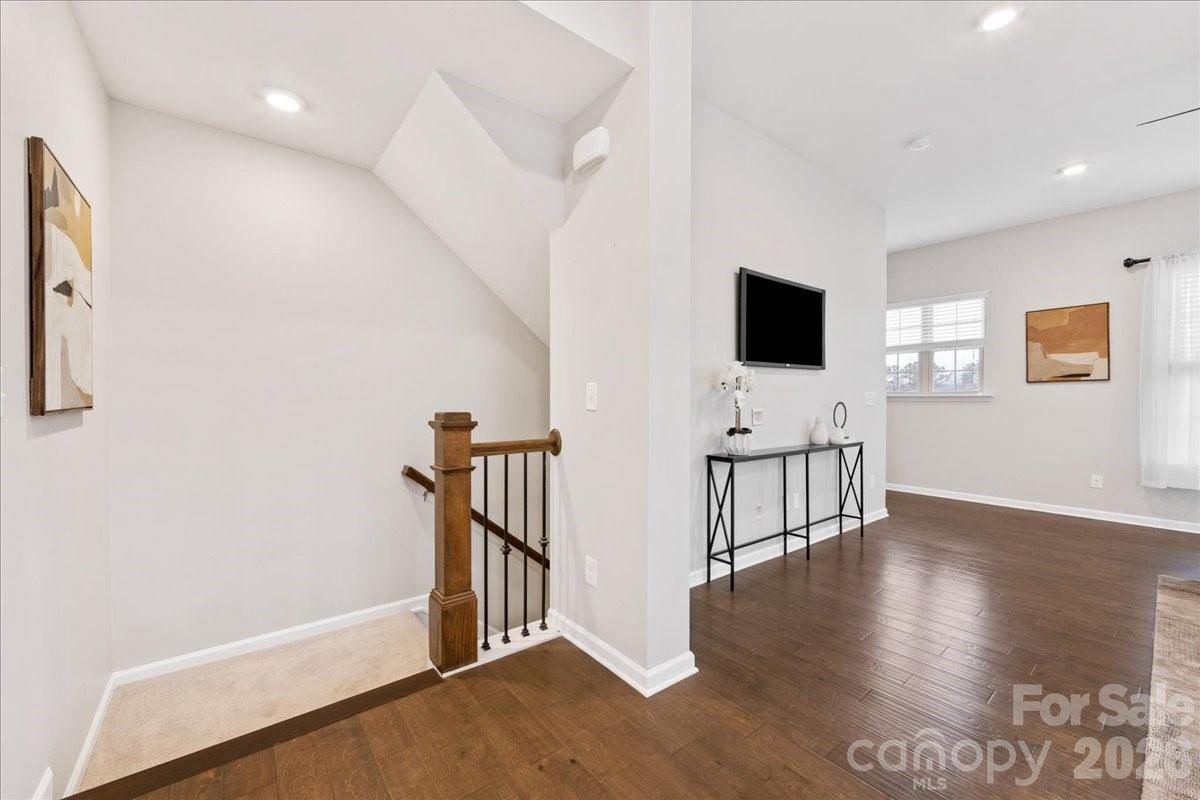 9205 Bluefield Street Charlotte, NC 28273 - Photo 8 of 48 a view of a livingroom with wooden floor and a flat screen tv