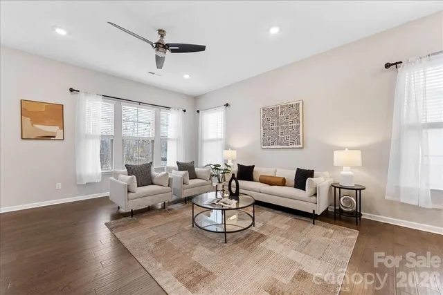 a living room with furniture or couch and a ceiling fan