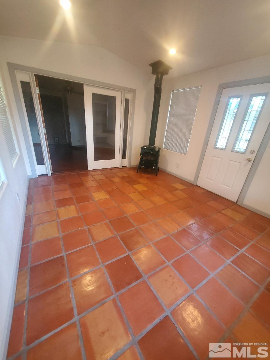975 Bejay Place Reno, NV 89509 - Photo 13 of 33 a view of an empty room with windows and chandelier