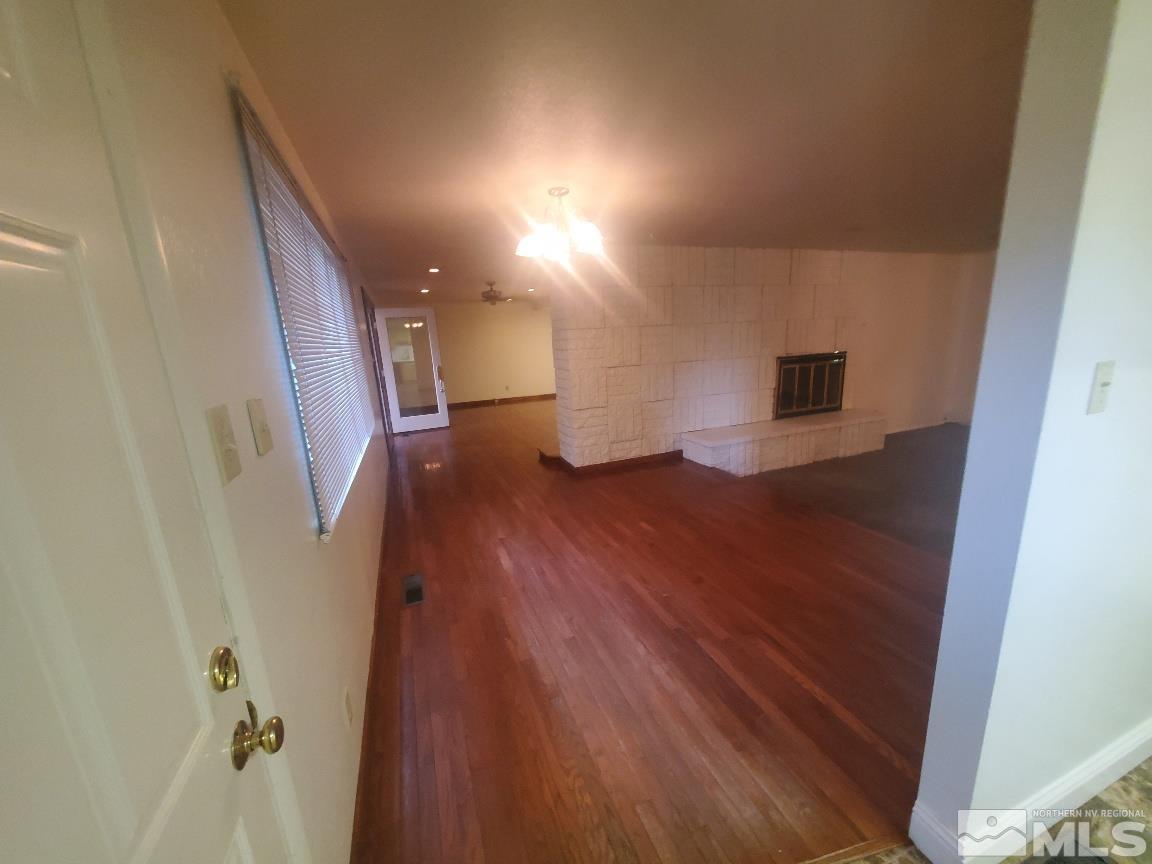 975 Bejay Place Reno, NV 89509 - Photo 16 of 33 a view of hallway with stairs and wooden floor