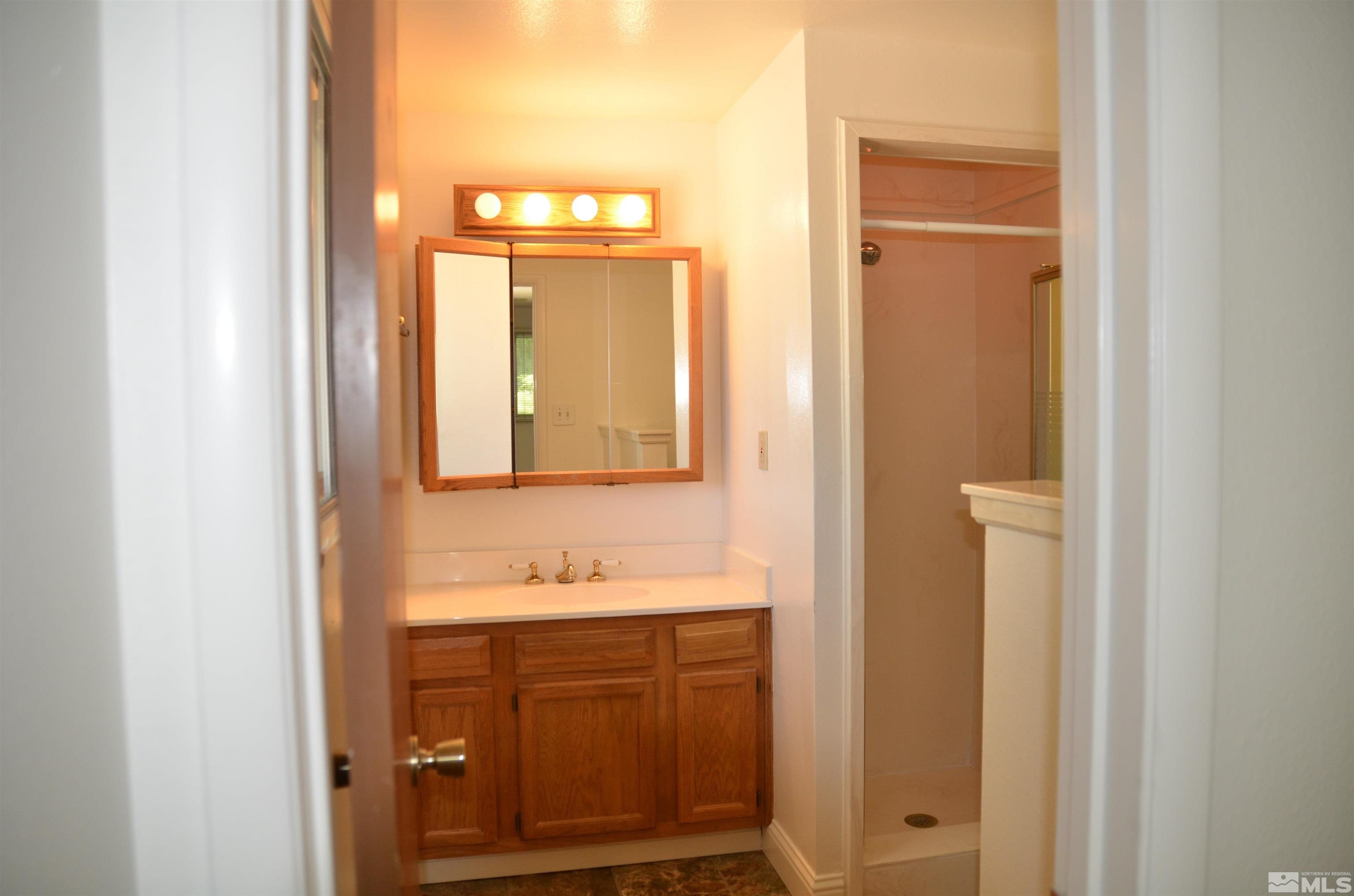 975 Bejay Place Reno, NV 89509 - Photo 18 of 33 a bathroom with a sink and a mirror