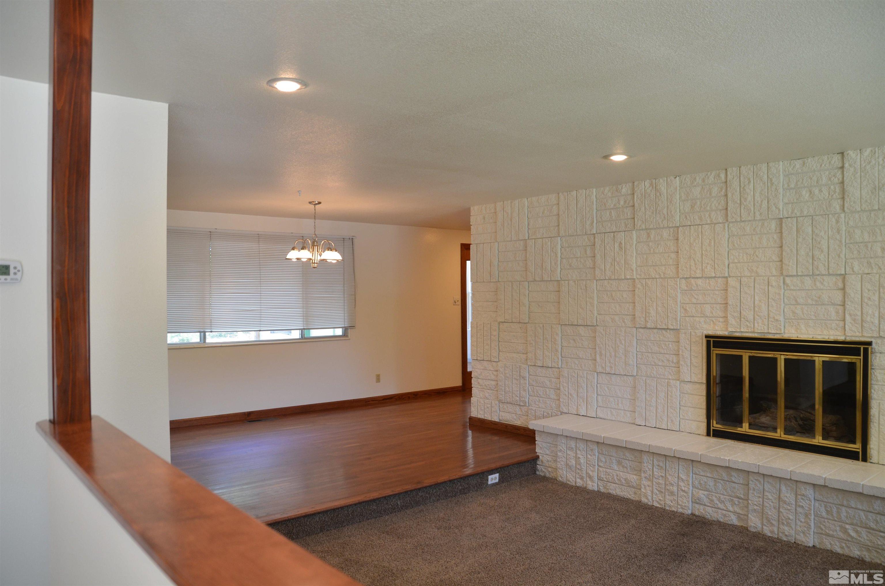 975 Bejay Place Reno, NV 89509 - Photo 2 of 33 a view of an empty room with a fireplace and a window
