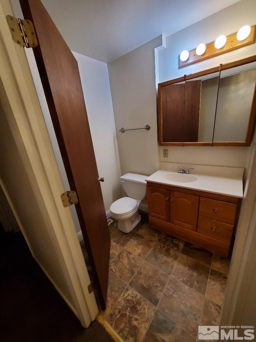 975 Bejay Place Reno, NV 89509 - Photo 21 of 33 a bathroom with a toilet sink and mirror