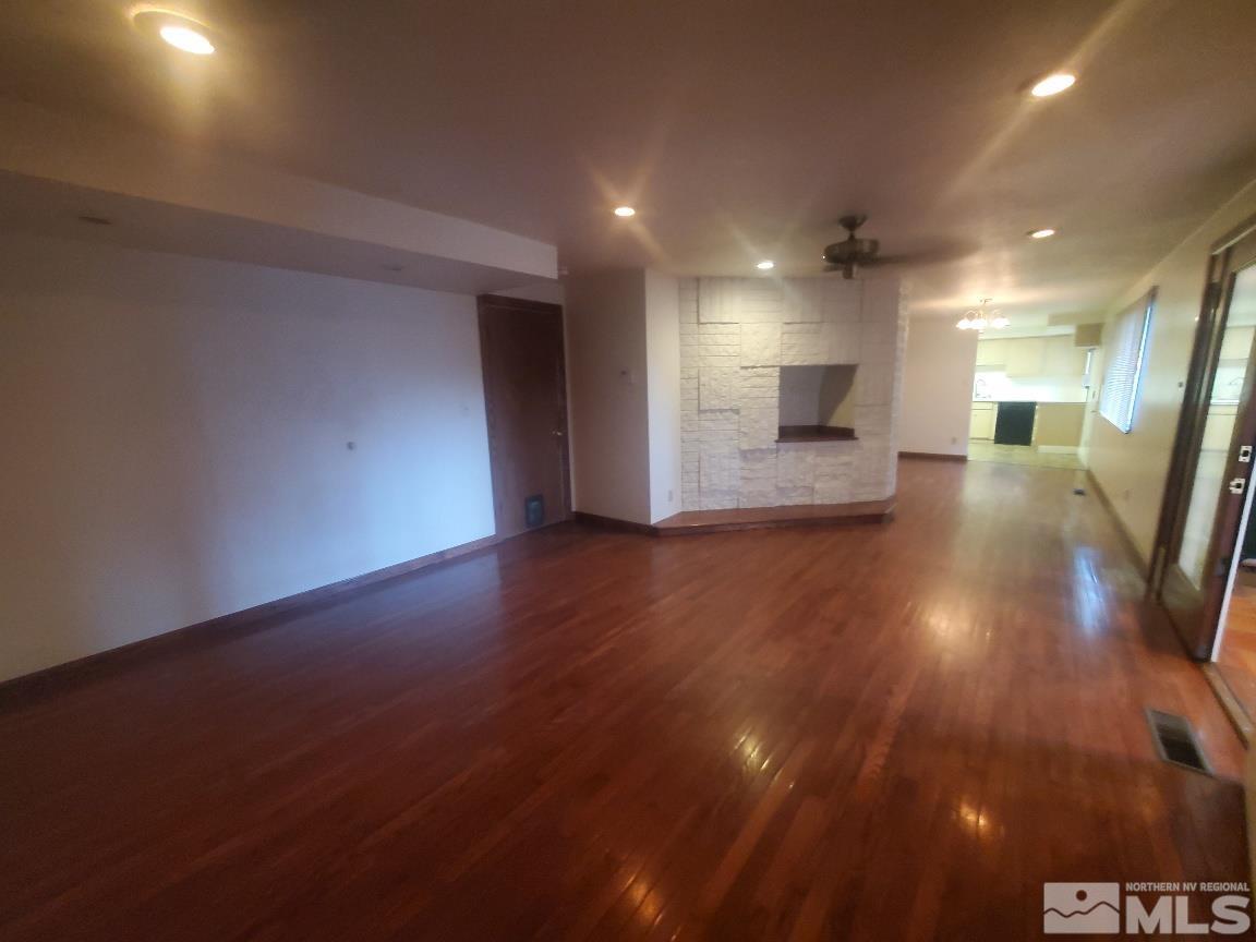 975 Bejay Place Reno, NV 89509 - Photo 22 of 33 an empty room with wooden floor and windows
