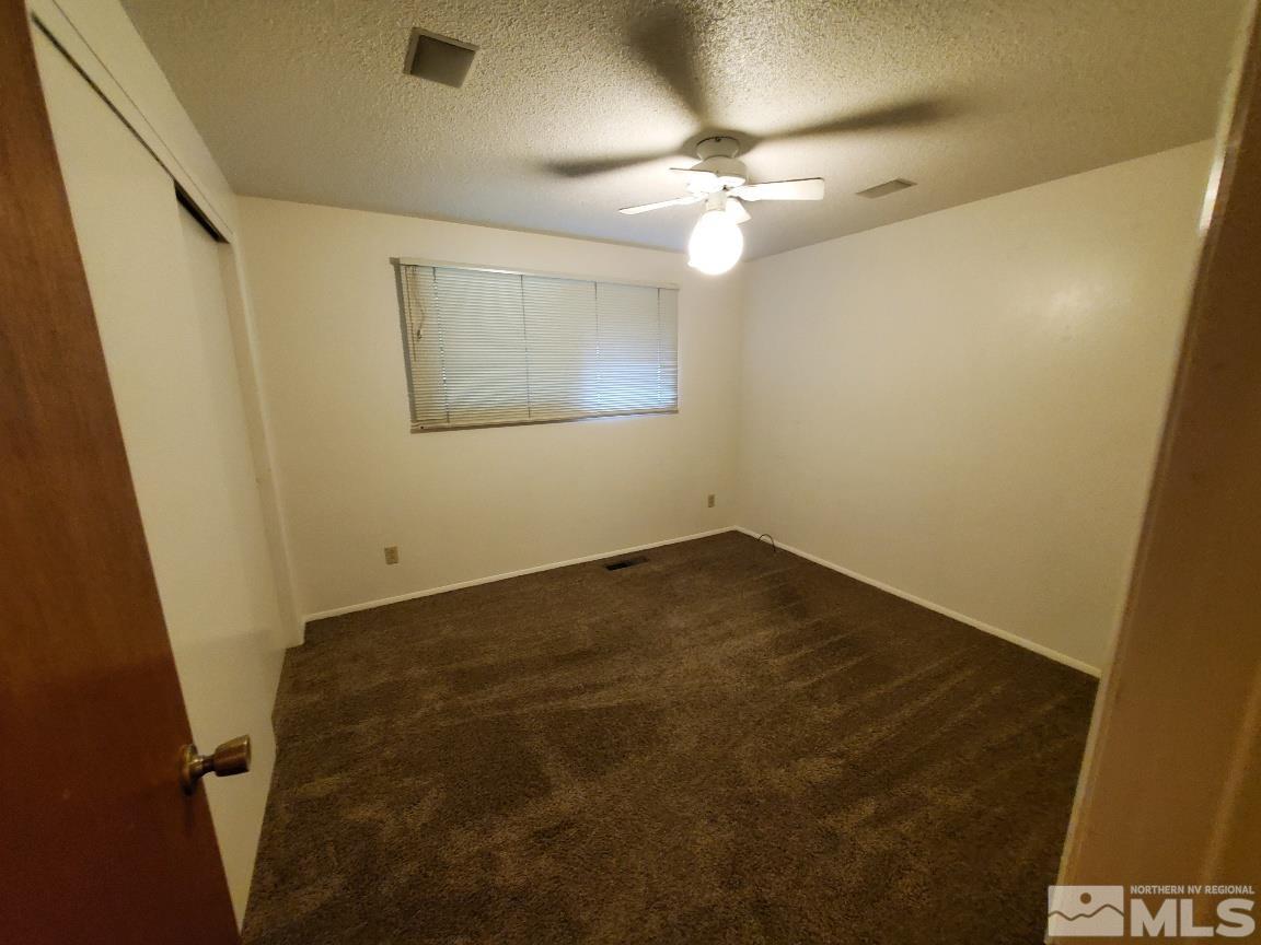 975 Bejay Place Reno, NV 89509 - Photo 24 of 33 en empty room with wooden floor and fan