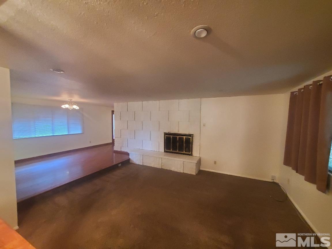 975 Bejay Place Reno, NV 89509 - Photo 3 of 33 a view of an empty room with a fireplace