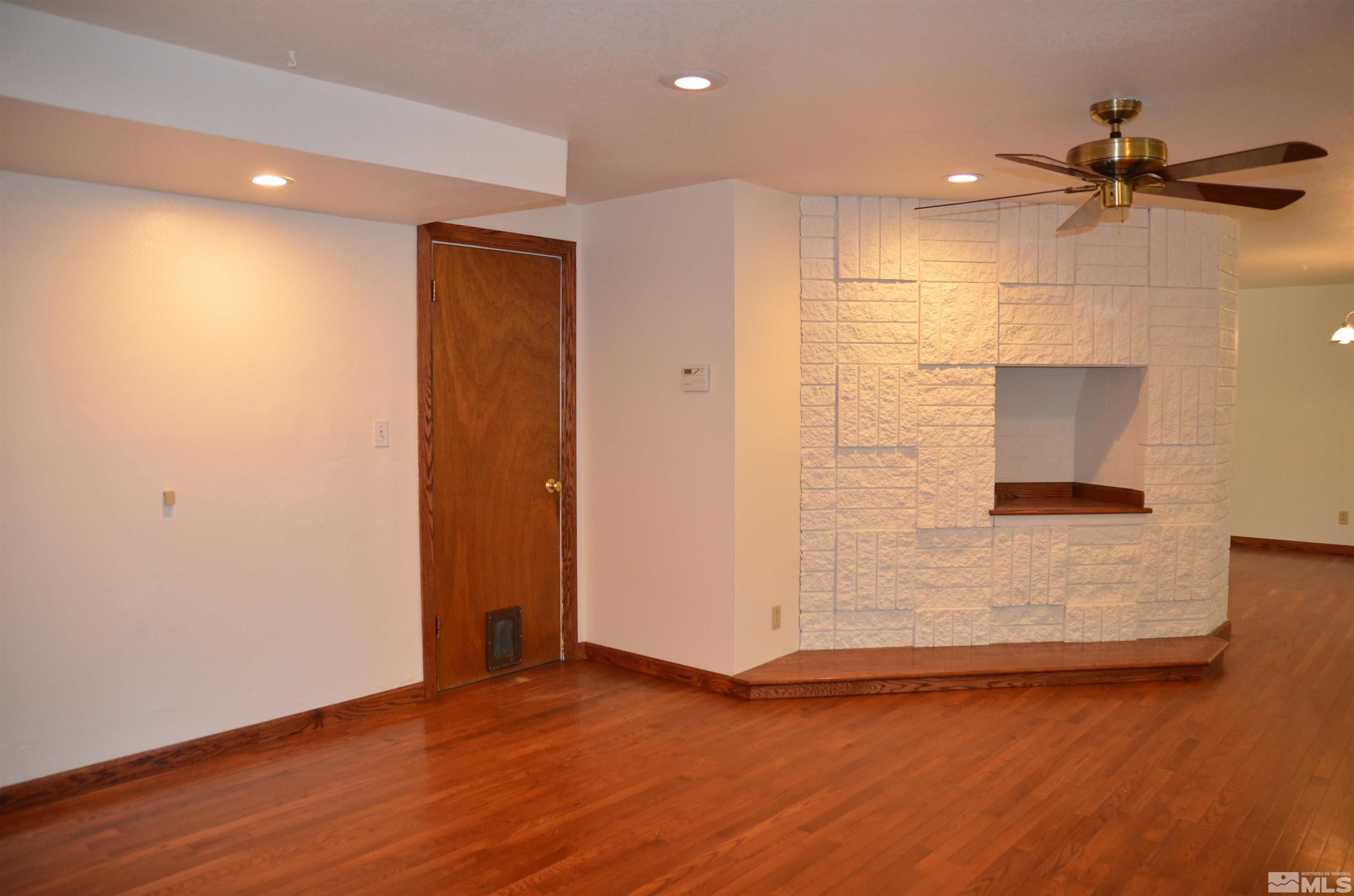 975 Bejay Place Reno, NV 89509 - Photo 10 of 33 an empty room with wooden floor and windows