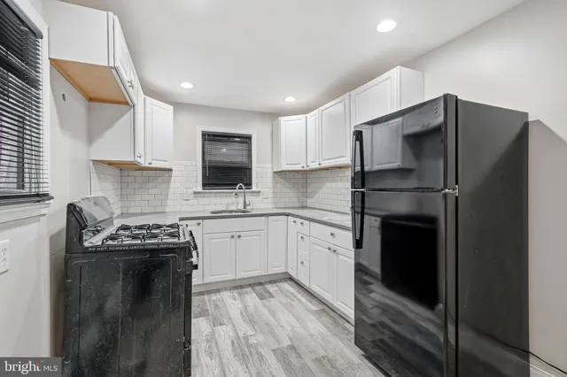 a kitchen with a refrigerator stove and sink